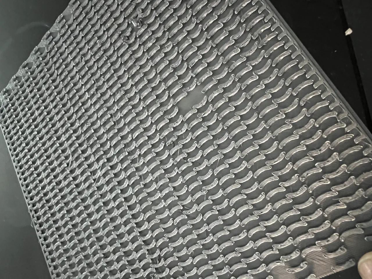 A large sheet of silver plastic covered in bumps, with two small areas clear of bumps