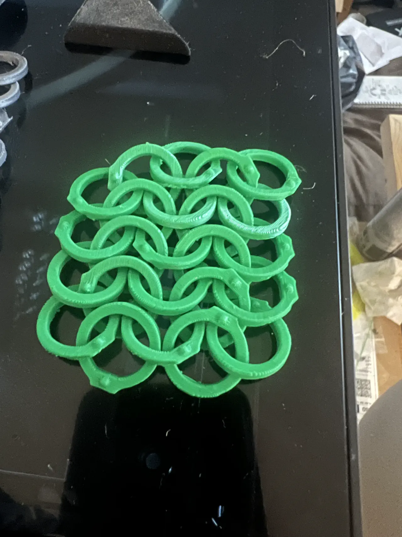 A section of the flat ringed chainmail but in bright green