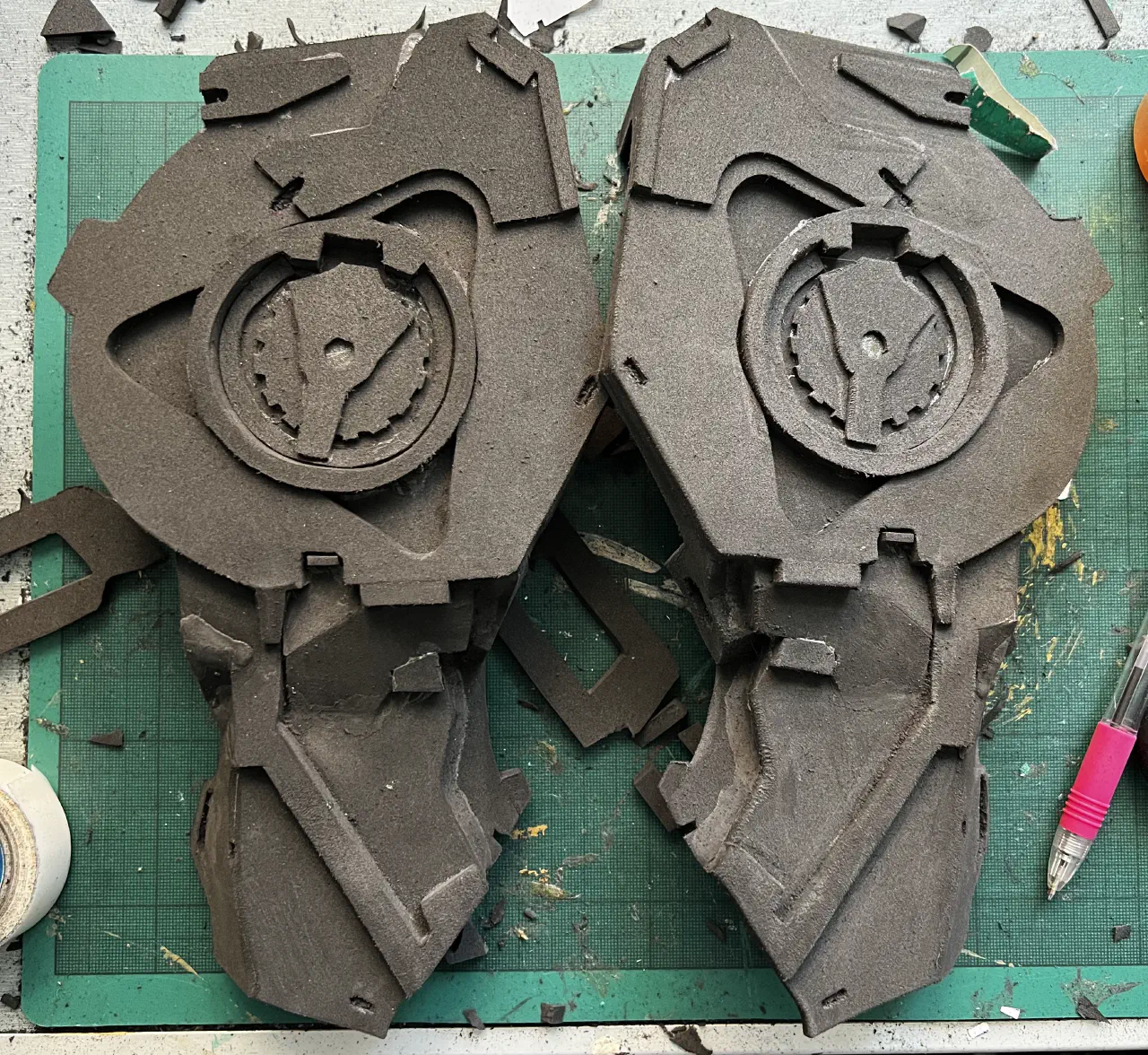 Two side-by side of arm armour, completed and resting on a tabletop.