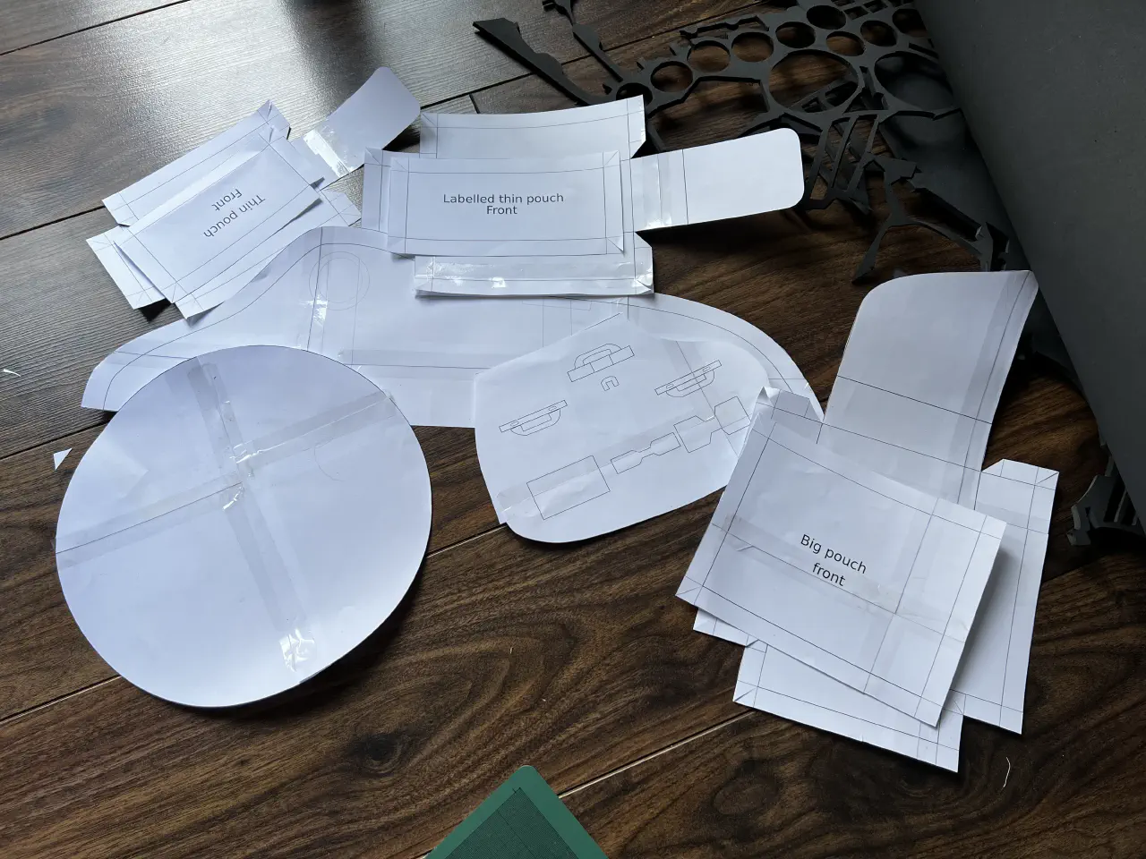 A pile of printed paper templates, some taped together.