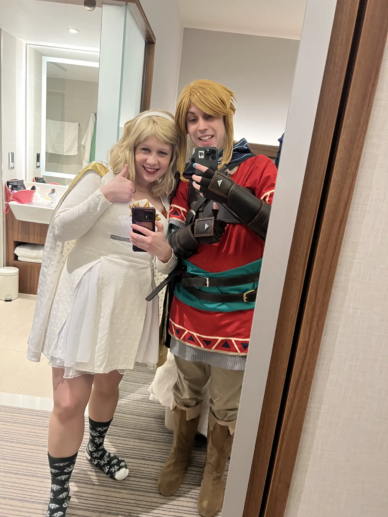 A selfie taken with the help of a mirror containing Starlight and Link cosplays.