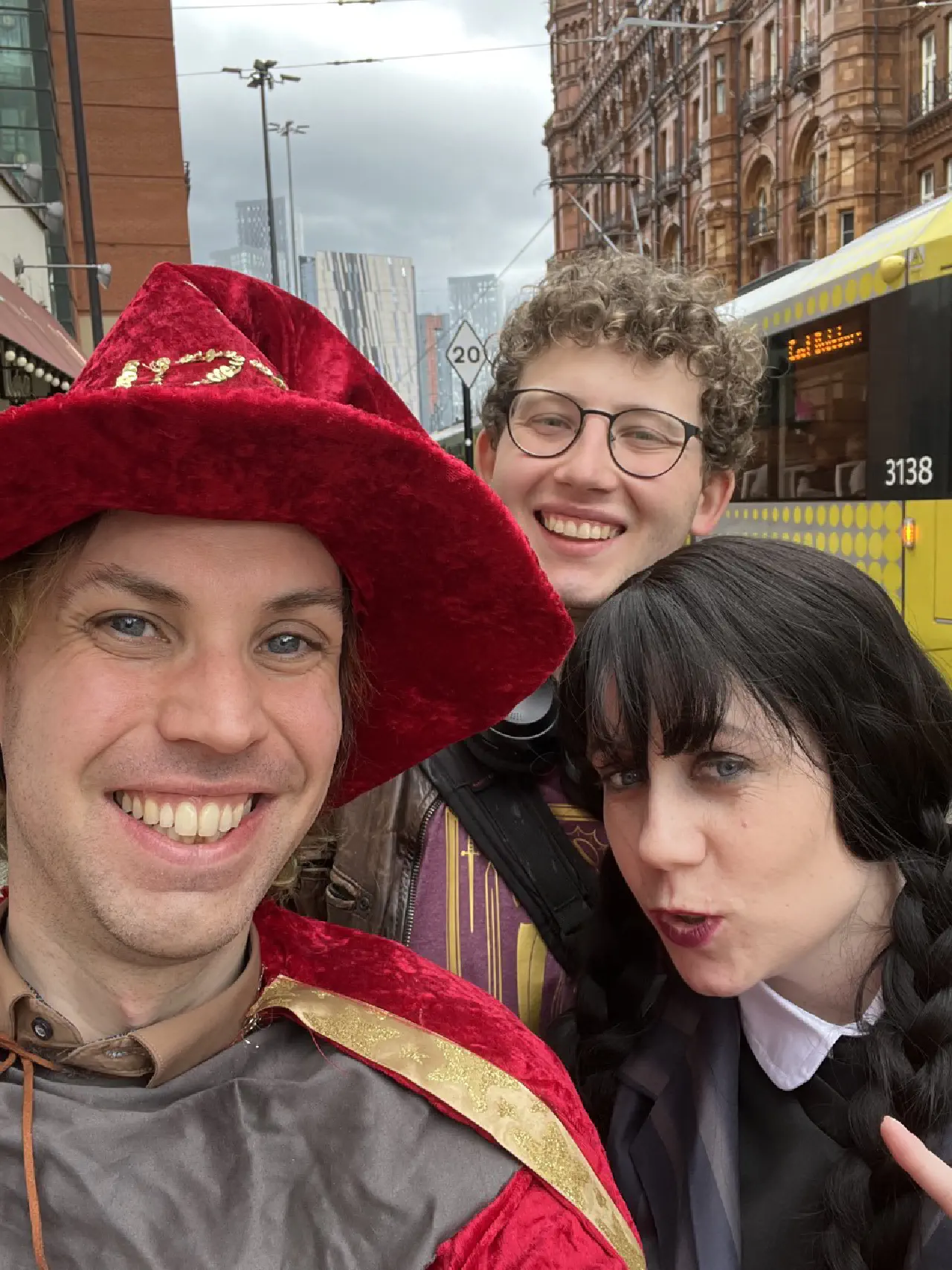 Selfie of us all, Rincewind, Wednesday and Nate not in costume. A tram has photobombed us in the background.