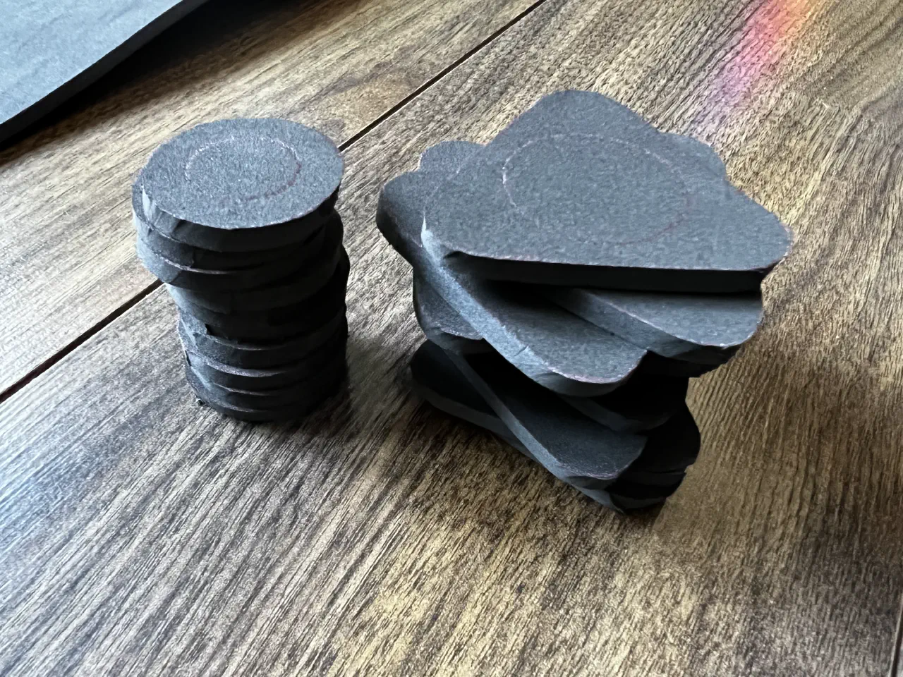 A pile or circular and rounded triangular pieces of foam stacked on top of each other